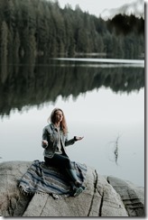 Woman meditating on lake